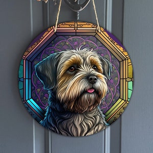 May include: A round, colorful, stained glass-style door hanger featuring a portrait of a brown and white dog with a pink tongue sticking out. The dog is surrounded by a purple, blue, and green stained glass design.