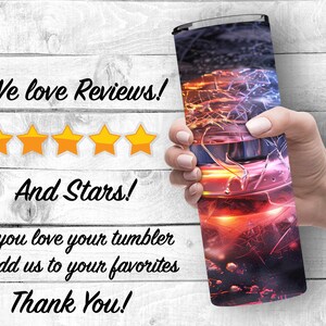 May include: A stainless steel tumbler with a colorful abstract design featuring red, orange, yellow, blue, and purple hues. The tumbler is being held by a hand. The text "We love Reviews!" and "And Stars!" is displayed above a five-star rating. The text "If you love your tumbler Add us to your favorites Thank You!" is also displayed.