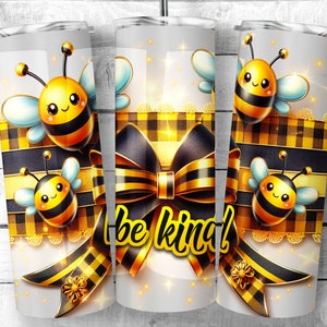 May include: A white tumbler with a black and yellow checkered pattern, a gold bow, and a bee design. The tumbler has the text "be kind!" on it.