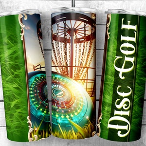 May include: A green and gold tumbler with a disc golf basket and disc on one side and the words "Disc Golf" on the other side.