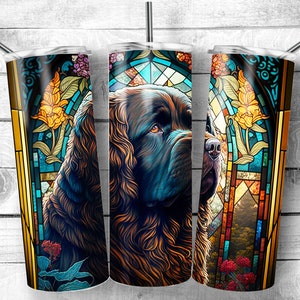 May include: A stainless steel tumbler with a colorful stained glass design featuring a Newfoundland dog. The design includes a floral motif and a background of blue, green, and yellow.