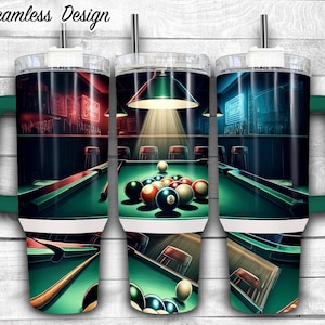 May include: A green and white stainless steel tumbler with a seamless design featuring a pool table with billiard balls and a cue stick. The tumbler has a lid and a handle.