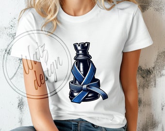 May include: A white t-shirt featuring a black chess rook piece wrapped in a blue martial arts belt. The chess piece is positioned in the centre of the shirt.