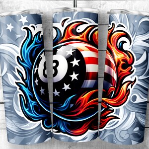 May include: A stainless steel tumbler with a design of a red, white, and blue 8-ball with flames on either side. The background is a gray and white swirl pattern.