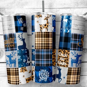 May include: Three stainless steel tumblers with a patchwork design featuring blue and brown plaid, reindeer, snowflakes, and the text "Ho Ho Ho", "Santa Please", "Deck the Halls", and "Love Peace Joy".