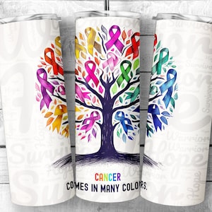 May include: A white tumbler with a colorful ribbon tree design. The text "CANCER COMES IN MANY COLORS." is printed on the tumbler.