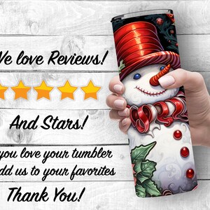 May include: A white snowman with a red hat and candy cane scarf on a black and green tumbler. The tumbler is being held by a hand. The text "We love Reviews!" and "And Stars!" is visible in the image. The text "If you love your tumbler Add us to your favorites Thank You!" is also visible.