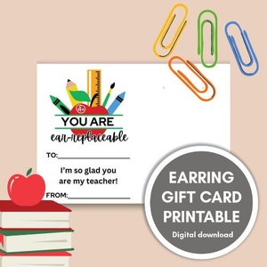 May include: Printable gift card for an earring purchase. The card features a red apple with school supplies and the text "You are ear-replaceable".