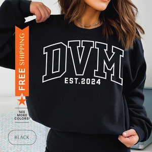 May include: Black sweatshirt with white text that reads "DVM EST. 2024".