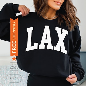 May include: Black sweatshirt with white text that says "LAX" on the front.