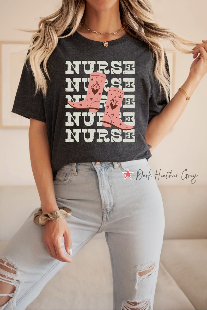 May include: Dark heather grey t-shirt with the text "NURSE" repeated five times and a graphic of pink cowboy boots with flames and hearts.