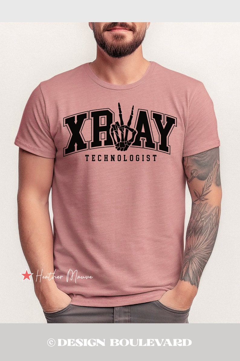 May include: A heather mauve t-shirt featuring a black graphic of a skeleton hand making a peace sign. The text "X-RAY TECHNOLOGIST" is printed below the graphic.