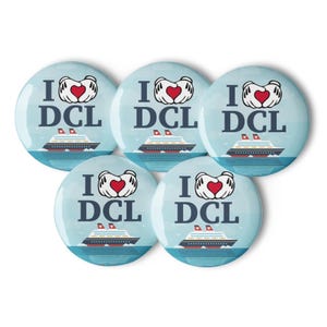 May include: Five circular badges with a pale blue backdrop. Each badge displays the text "I ❤️ DCL" above a cruise ship illustration. The heart is red, and the ship is white and red.