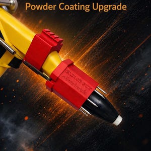 May include: A yellow powder coating corona ring attachment for a grease gun, featuring two red plastic components. The red part is embossed with the text Grease Gun Metalwerks. The device has a black nozzle tip and metallic prongs.