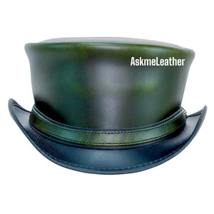 May include: A green leather top hat with a black leather band and brim. The hat has a distressed look and the text "AskmeLeather" is visible on the top.