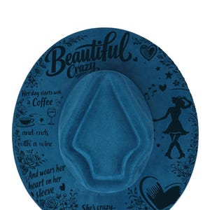 May include: A dark blue felt fedora hat featuring black printed text and graphics. The brim displays the words Beautiful Crazy, Her day starts with a Coffee and ends with a wine, And wears her heart on her sleeve, and She's crazy But her crazy's beautiful to me, alongside illustrations of roses, a coffee cup, a wine glass, a heart, and a dancing silhouette.