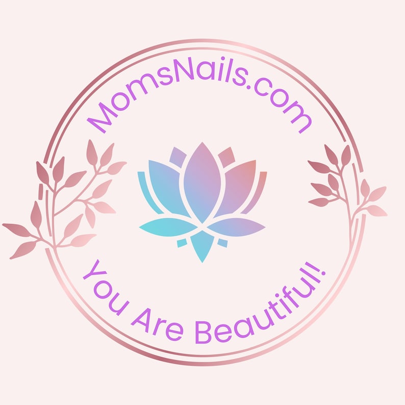 May include: A circular logo with a gradient lotus flower in shades of blue, purple, and pink. The text "MomsNails.com" arches above the flower, and "You Are Beautiful!" curves below. The logo is framed by a rose gold double circle and floral accents.