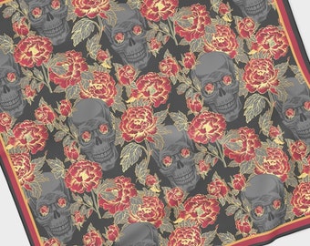 May include: Square scarf featuring a repeating pattern of grey skulls and red and gold flowers on a black backdrop. The scarf has a red and gold border.