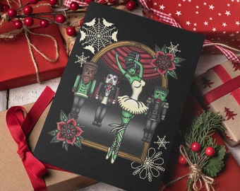 May include: A black Christmas card with a green monster ballerina dancing with a werewolf, vampire, and Frankenstein's monster. The card is surrounded by red and brown gift boxes with festive wrapping paper.