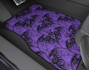 May include: Purple car floor mat with a black lace pattern featuring bats. The mat is made of a durable material and is designed to protect your car's interior.