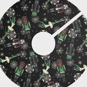 May include: Black tree skirt with a repeating pattern of nutcrackers, Frankenstein's monster, werewolves, and ballerinas. The design includes snowflakes and spiderwebs. The skirt has a circular shape with a split for the tree trunk.