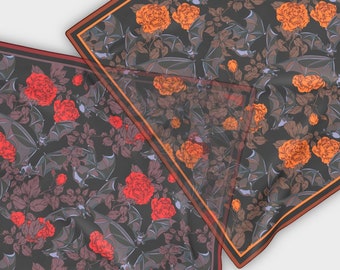 May include: Two square scarves with a black background and a repeating pattern of bats, roses, and leaves. One scarf has red roses and the other has orange roses.