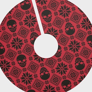 May include: Red Christmas tree skirt with a black and white skull and snowflake pattern.