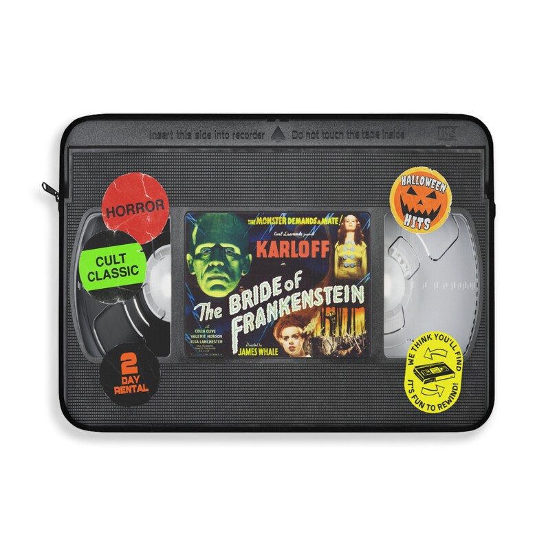 Retro Horror VHS Laptop Sleeve available in three sizes to protect your laptop. Printed on one side with a black backside, edging and zip, the perfect addition to your movie monsters, 80s, 90s, VHS tape Frankenstein, Dracula, themed desk or computer.