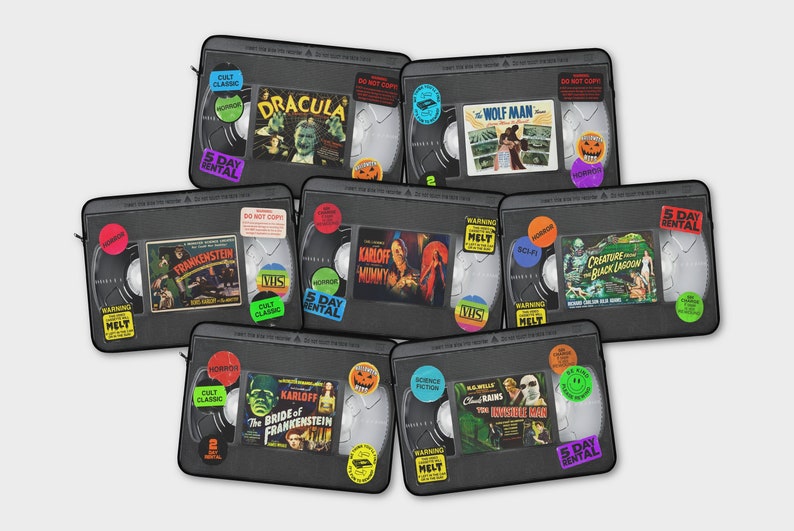 Retro Horror VHS Laptop Sleeve available in three sizes to protect your laptop. Printed on one side with a black backside, edging and zip, the perfect addition to your movie monsters, 80s, 90s, VHS tape Frankenstein, Dracula, themed desk or computer.