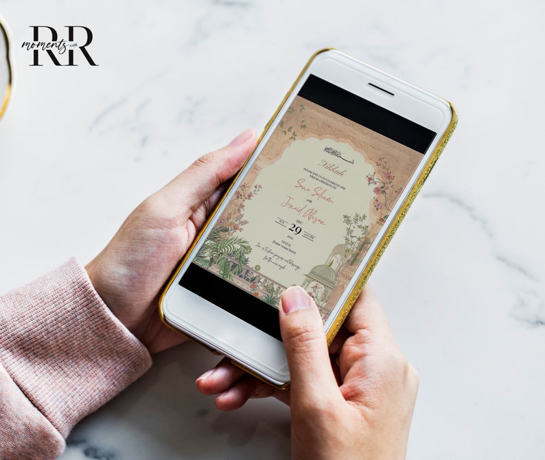 May include: A smartphone displaying a wedding invitation with a floral design. The invitation reads "Nikah" and includes the names "Sana Sheikh" and "Farid Ali" with the date "29-20".