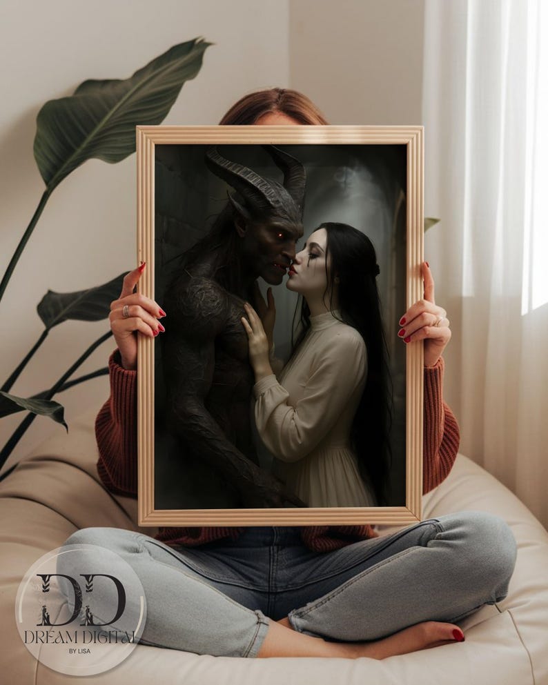 May include: A rectangular wooden frame containing a digital print of a dark-skinned horned creature with glowing eyes facing a pale-skinned person with long black hair wearing a cream-colored long-sleeved dress. The print features the text DREAM DIGITAL BY LISA.