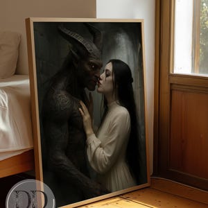 May include: A framed rectangular wall art print featuring a dark-skinned horned creature with glowing red eyes facing a person with long black hair wearing a cream-colored high-neck dress. The print includes the text DREAM DIGITAL BY LISA.