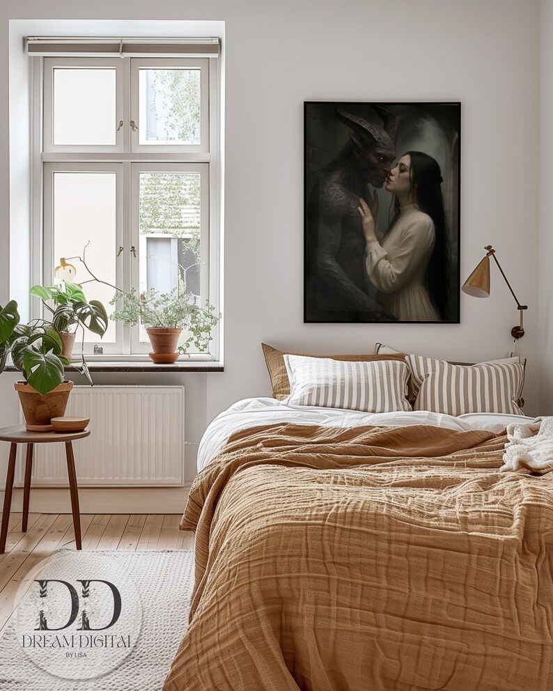 May include: A framed wall art print depicting a dark-skinned horned figure with textured skin standing close to a person with long dark hair wearing a cream-colored long-sleeved garment. The artwork features a moody, atmospheric aesthetic with deep shadows.