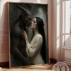 May include: A framed digital art print depicting a dark-skinned, horned creature with glowing orange eyes facing a person with long black hair wearing a cream-colored long-sleeved dress. The print includes the text DD DREAM DIGITAL BY LISA.