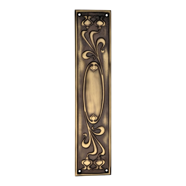 May include: An antique brass door plate with an Art Nouveau design. The rectangular plate features an oval centre and stylized floral and vine motifs. The design is raised, creating a three-dimensional effect. There are four screw holes for mounting.