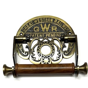 May include: Brass toilet roll holder with a decorative design featuring the words "Great Western Railway" and "GWR Patent Pending".