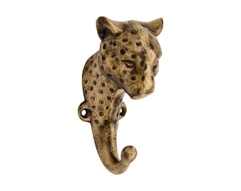 May include: A wall-mounted hook crafted from antique brass-toned metal, featuring the sculpted head and neck of a leopard. The surface displays a textured, spotted pattern across the feline form, with two circular mounting holes at the base.