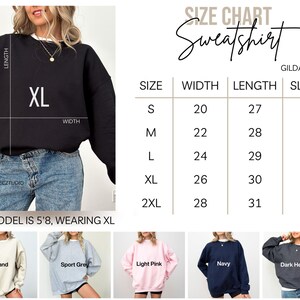 The image is a size chart for a black sweatshirt, including various sizes and corresponding measurements.