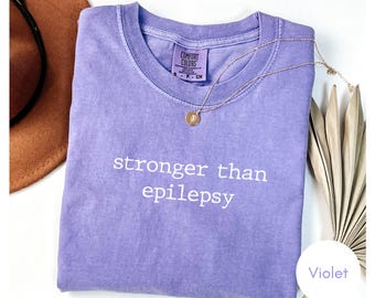 Camiseta de concienciación sobre la epilepsia, "Más fuerte que la epilepsia", camiseta de guerrero, camiseta gráfica de estilo vintage con colores cómodos.