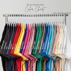 A clothing rack displaying a variety of colorful t-shirts, each with a different color and design.