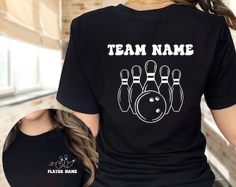 May include: Black t-shirt with a white bowling ball and pins graphic on the back. The text "TEAM NAME" is above the graphic. The front of the shirt has a smaller graphic of a bowling ball and pins with the text "PLAYER NAME".