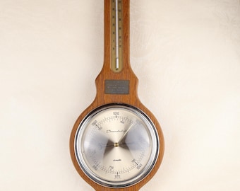 Barómetro de pared vintage, estación meteorológica de madera, termómetro e higrómetro, fabricado en Alemania a mediados de siglo.