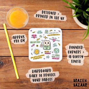 May include: White square coaster with rounded corners and a glossy finish. The coaster features a colorful doodle design with motivational quotes and a teabag illustration. The text on the coaster reads "Slay the Day", "You are Amazing", "You Got This!" "Every Day is a New Opportunity", "Follow Your Heart", "Keep Going", "Positivi-Tea", "Believe in Yourself", "You Bring Sunshine & Happiness", "The World Needs What You've Got". The coaster is approximately 9x9 cm.