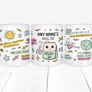 May include: Three white ceramic mugs with colorful hand-drawn designs and inspirational quotes. The mugs feature a sun, a tea bag with a face, and a globe. The text on the mugs includes "You bring sunshine & happiness", "Any Name's Mug of Positivi-Tea", and "Every day is a new opportunity".