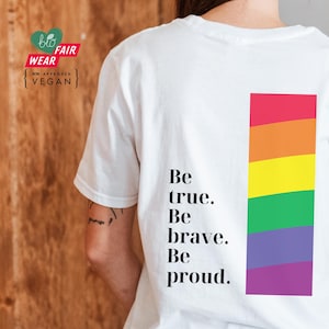 May include: White t-shirt with a rainbow stripe design and the text "Be true. Be brave. Be proud."