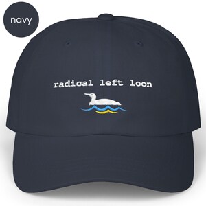May include: Navy blue baseball cap with the embroidered text "radical left loon" above a white loon graphic on blue and yellow waves. The cap is a classic six-panel design.