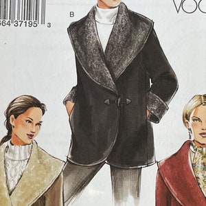 May include: A sewing pattern for a coat with a large collar. The pattern is for sizes S and M. The pattern is from Very Easy Vogue and has the number 7806.