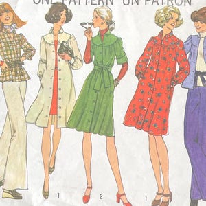 May include: Simplicity sewing pattern envelope featuring illustrations of five women in 1970s fashion. The designs include a plaid jacket and pants, a long coat, a button-down dress, a floral dress, and a jacket with pants. The envelope reads "ONE PATTERN UN PATRON".