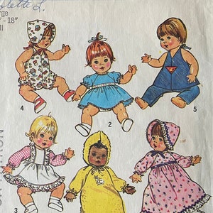 May include: A vintage Simplicity sewing pattern, number 7208, for a large doll, 43-46 cm. The pattern shows illustrations of dolls in various outfits, including dresses, overalls, and a hooded jumpsuit. The pattern includes the text "Colette L." and "Simplicity".