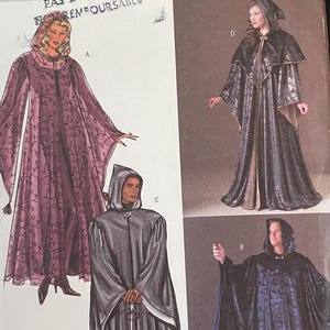 May include: Butterick 4050 sewing pattern envelope featuring illustrations of hooded cloaks and robes in various styles. The front displays four distinct garment designs labeled A, B, C, and D, with a barcode and size L, XL printed at the top right corner.
